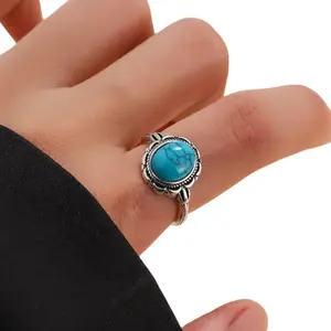Vintage Style Open Ring Featuring an Oval Turquoise Stone with a Unique Ethnic Design