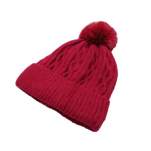 THE CLASSIC POMPOM BEANIE; ultra-soft knit fabric, premium blend of acrylic, polyester, and soft faux fur for lasting warmth and durability.
