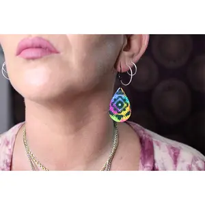 Bright colored tie dye with black background. Tie-dye dangle and drop style hypoallergenic hook earrings.