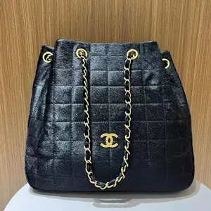 Pre-owned CHANEL Suede Shoulder Bags Bucket Bag: Black Diamond Patterned Crossbody Bag with Gold Hardware (Vintage)