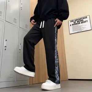 Men’s casual pants featuring an elastic waistband and drawstring design, floral side pattern, side pockets, and slight stretch—comfortable athletic casual pants.