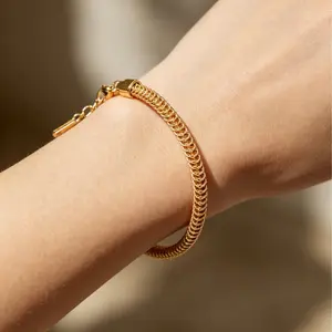 Gold woven bracelet with adjustable chain—creates a minimalist, premium look and is perfect for stacking on the wrist.