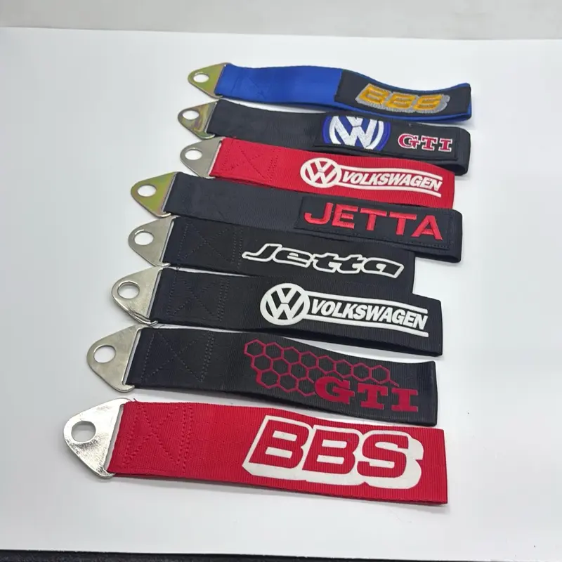 Functional fabric tow straps featuring themed Volkswagen and BBS embroidery. The straps display various logos, including "GTI," "Jetta," and the circular Volkswagen emblem.