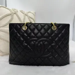 Pre-owned CHANEL Grand Shopping Tote (GST) bag in black caviar leather with gold hardware