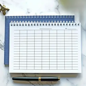A5 spiral bound grid notebook-100 pages, blue texture cover, horizontal/vertical layout, used for time tracking, accounting, inventory management and activity planning, suitable for school use.