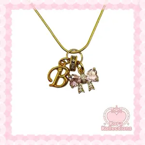 handmade gold bow dream initial charm necklace by kora kollections with plated chain
