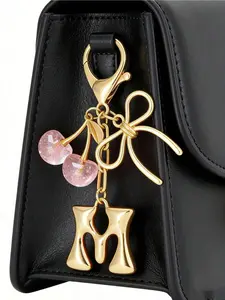 Fashion cherry & golden butterfly bag charm keychain with alloy A-Z letter pendants. Sparkling resin and metal accessory with clip for handbags, backpacks and earphone decor. Perfect Mother's Day gift for women. Fashion Bag Charms