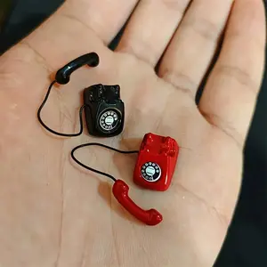 Two miniature vintage rotary phone models- alloy metal decoration, red and black color scheme with white accents, realistic dial and cord, suitable for dollhouse accessories, scene props, collection