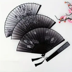 Stylish vintage bamboo folding fan with tassel - Portable handheld summer fan, perfect for celebrations, events, and gifts.  Features a solid color design with floral details.  Event accessory | Decorative fan | Easy-to-carry fan