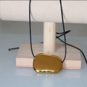 Kira Necklace - Gold Pendant on Black Cord Jewelry Piece