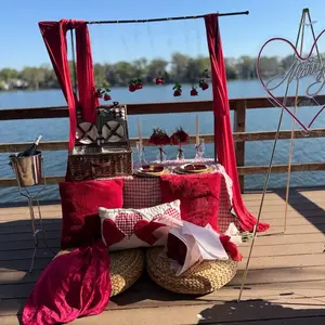 Romantic Picnic Proposal Setup with Red Drapes, Heart Decor, and Picnic Basket for a Memorable Date