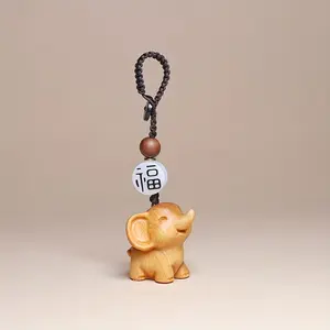 1pc Handcrafted wooden elephant pendant, a cute collectible figurine. Suitable for use in cars, desks, and home decorations. Can be used indoors and outdoors. A gift for family and friends - no electricity required. Car Key Accessory
