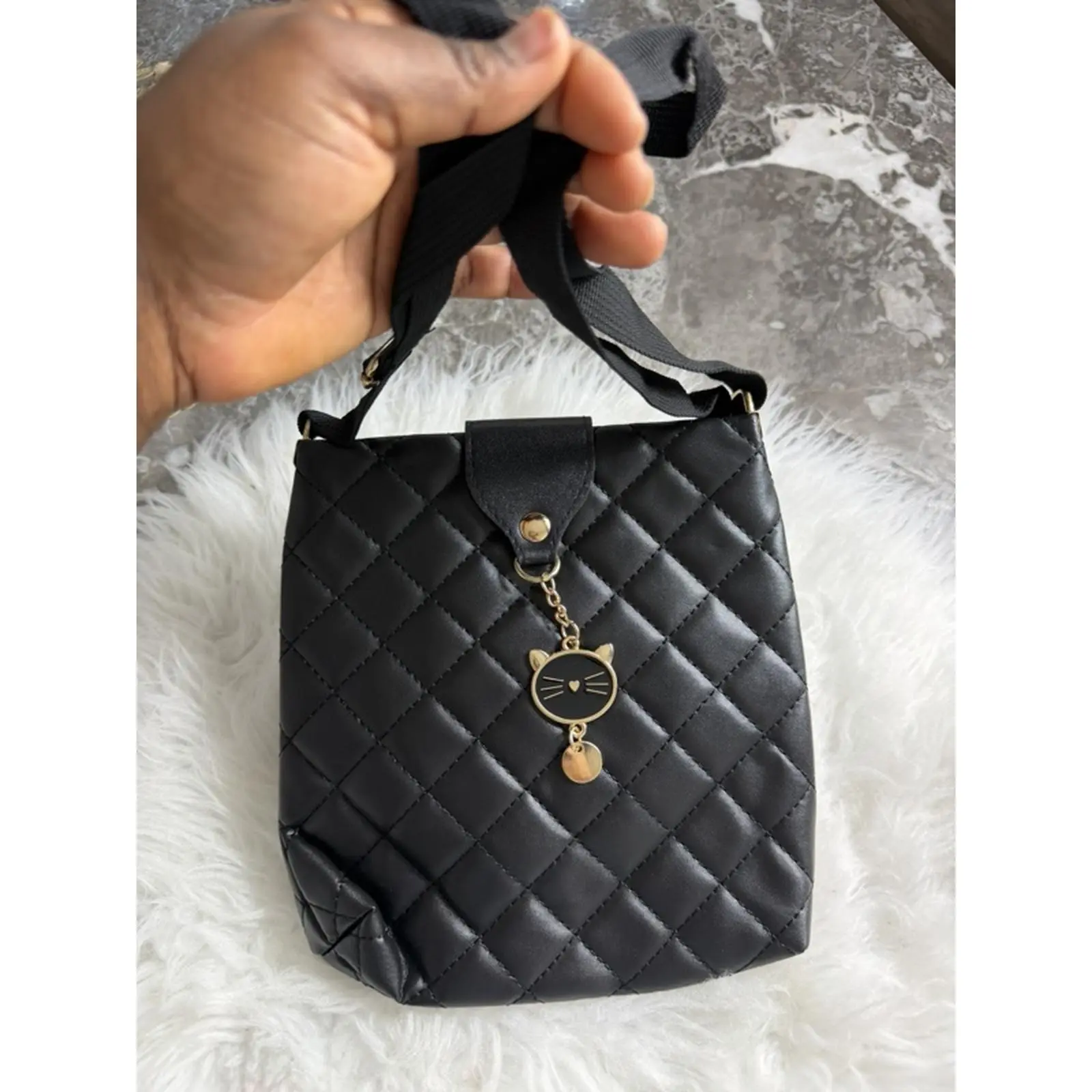 Quilted Black Handbag with Cat Charm and Adjustable Strap for Everyday Use