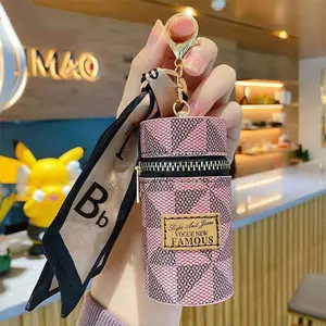 Women’s portable carry items: coins, lipstick, earphones, keys, storage pouch, gold decorative accents