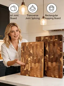 The Acacia chopping board features serrated edges and a non-slip base. This large kitchen cutting board showcases natural wood grain and is made from solid wood. It is a durable and easy-to-clean tool suitable for food preparation and dining services.