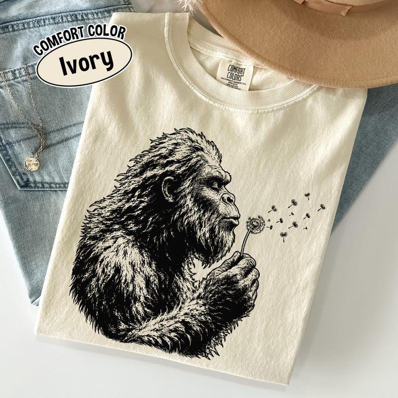 Comfort Colors Bigfoot Dandelion Shirt, Vintage Sasquatch Nature Tee, Woodland Cryptid Graphic T-Shirt, Outdoor Adventure Shirt, Bigfoot Lover Gift Comfort Colors Bigfoot Dandelion Shirt, Vintage Sasquatch Nature Tee, Woodland Cryptid Graphic T-Shirt, Outdoor Adventure Shirt, Bigfoot Lover Gift