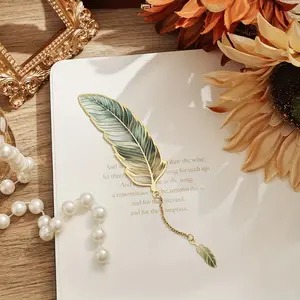 A vintage feather copper-toned metal bookmark with a metal chain pendant, perfectly suited for stationery needs. It's an ideal gift for birthdays, writers, teachers, friends, book club members, and book lovers.