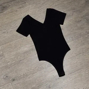 Black Ribbed V-Neck Short Sleeve Bodysuit for Women - Comfortable & Stylish One-Piece Outfit