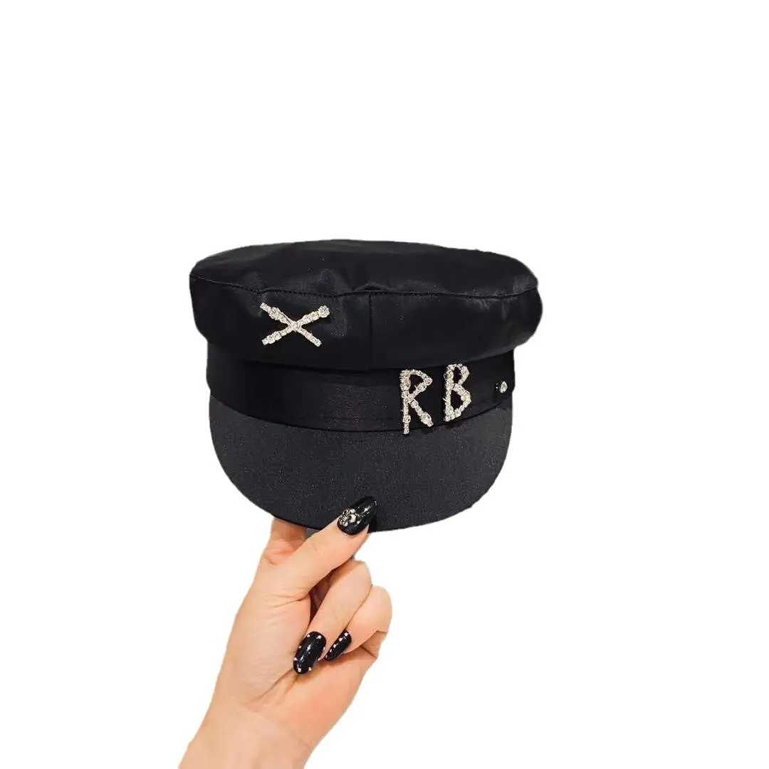 This high-gloss acetate sailor cap exudes urban chic, while its satin-lined hair-protecting newsboy cap adds a touch of sophistication.