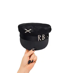 This high-gloss acetate sailor cap exudes urban chic, while its satin-lined hair-protecting newsboy cap adds a touch of sophistication.