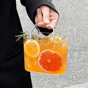1pc 700ml large-capacity tote-style glass cup, Funny glass cup, with handle and straw is a juice cup. Made of high borosilicate glass, it's reusable. Suitable for storing juices, iced drinks, milk tea, and coffee. A unique outdoor and kitch Glassware