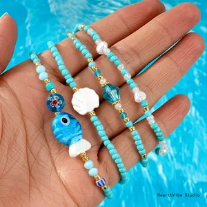 Niche & Whimsical Blue Glass Crystal Bracelet — Scallop Shell and Pearl-White Beaded Strand