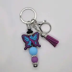 Charmingly Resilient Breast Cancer Awareness Bag Charm Purple Butterfly with Tassel and Beaded Details