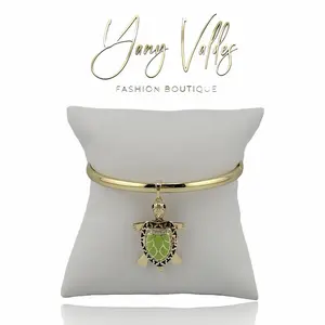 Open bangle bracelet with turtle pendant and gold plated finish