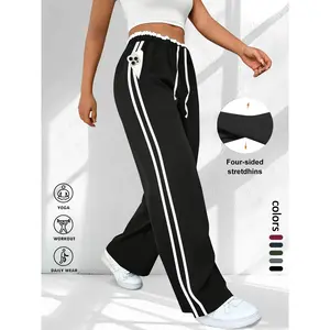 Plus-size women’s wide-leg sweatpants with an elastic waistband and drawstring waist, athleisure design featuring frill trim and pockets, sporty side-stripe trousers suitable for various occasions