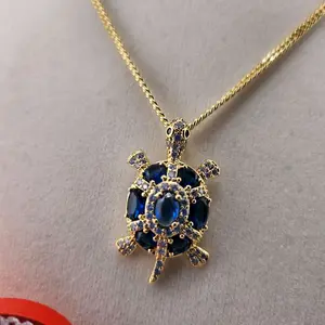 60 - Tortuga Diamantes Azul Pendant with Chain Elegant Gold-Tone Turtle Design Featuring Blue Gemstones and Sparkling Diamonds