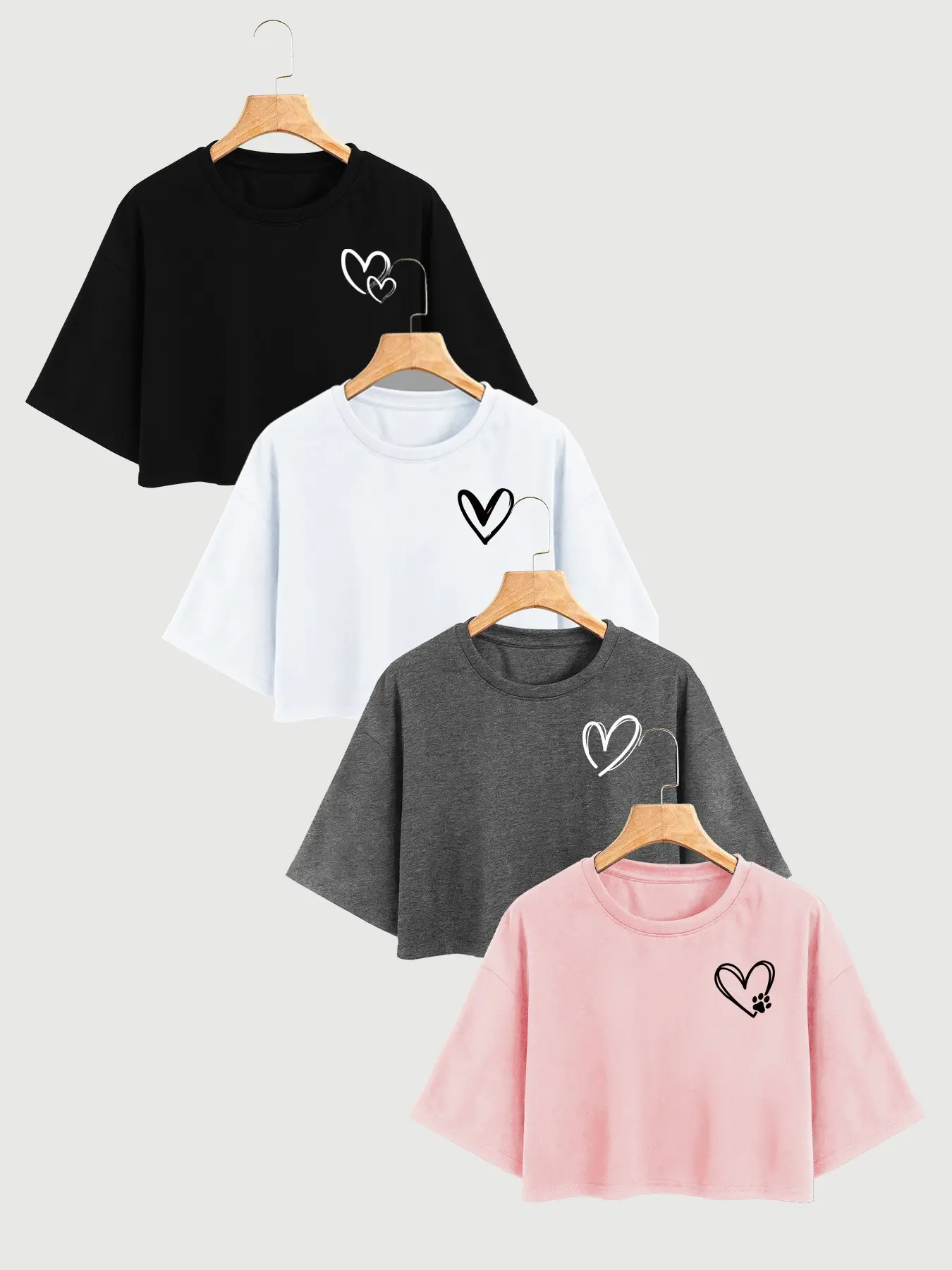 Women 4 Pack Heart Print Round Neck Drop Shoulder Short Sleeve Crop Tops Casual Y2K Streetwear Tees 2026 Trendy Aesthetic Loose Fit Cropped T Shirts Multipack for Summer Daily Vacation Street Style Comfy Soft Fabric Multiple Colors Available