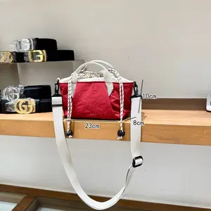 This KEMULA bag is mini-sized and can hold everyday essentials—lightweight yet durable, with a drawstring closure and crossbody option. It pairs perfectly with floral dresses and sweatshirts for a super sweet look, featuring macaron color tones.