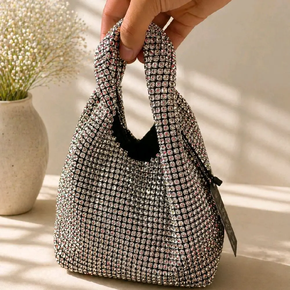 The bag that steals the spotlight!  Sparkle with confidence wherever you go. This stunning rhinestone handbag is the perfect accessory for weddings, parties, date nights, and every special occasion.