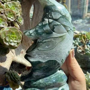 moss agate moom face carving with lots of geode