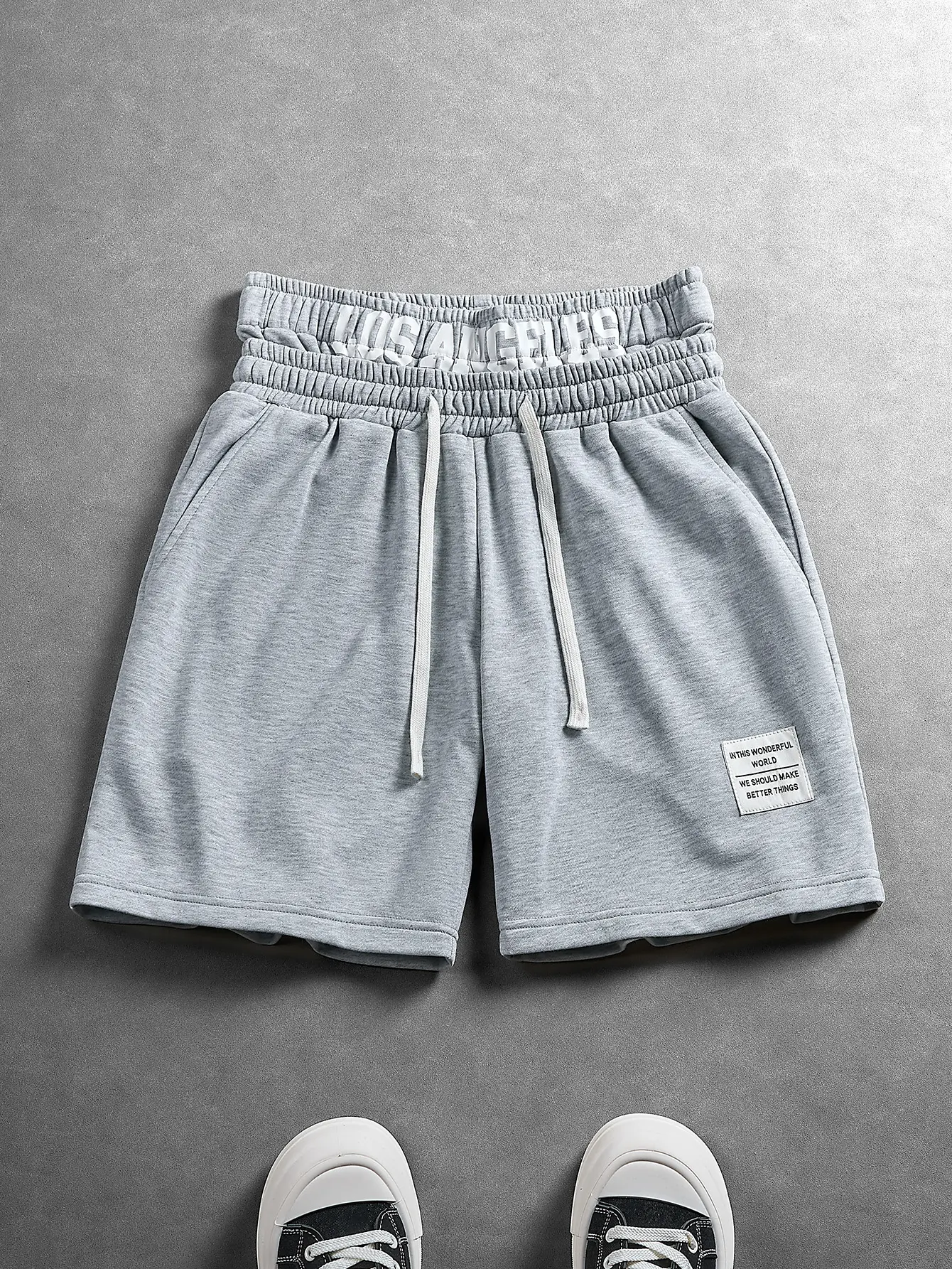 Unisex retro high street sweat shorts with 5" double layer waistband, 3D Los Angeles graphic, white drawstring, side and back pockets, woven label, light gray knit — viral gym and streetwear outfit