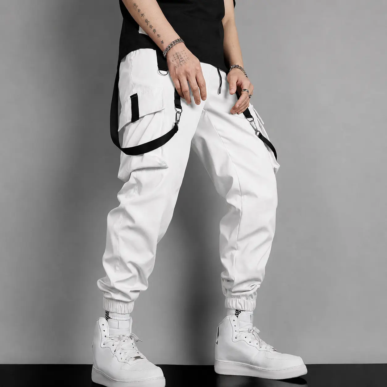 Men’s cargo pants with decorative straps and multiple pockets, jogger-style workwear pants with a drawstring elastic waistband; functional joggers for streetwear, casual everyday wear, sports, and activities.