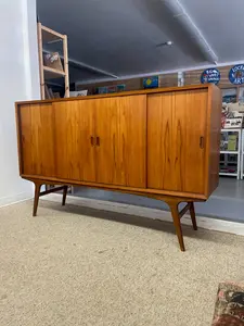 Mid-Century Danish Modern Likely Teak Credenza with Sculpted Base, Likely Rosewood Drawer Fronts with Brass toned Pulls (Available by Online Purchase Only)