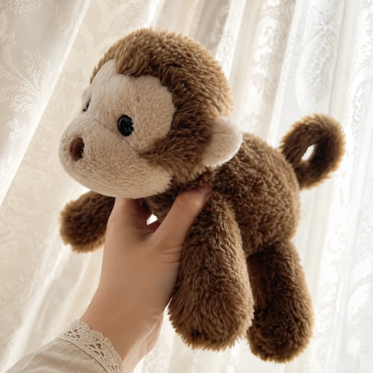 Jellycat's adorable brown curly-tailed monkey plush toy – A soft, cuddly stuffed toy perfect for collecting or as a gift for friends and family.