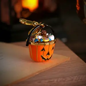 Glowing Halloween Keychain with Pumpkin Light & Skull Charm. This cute, cartoonish accessory is a fun addition to your keys, backpack, or car mirror. A great unisex gift for the season!