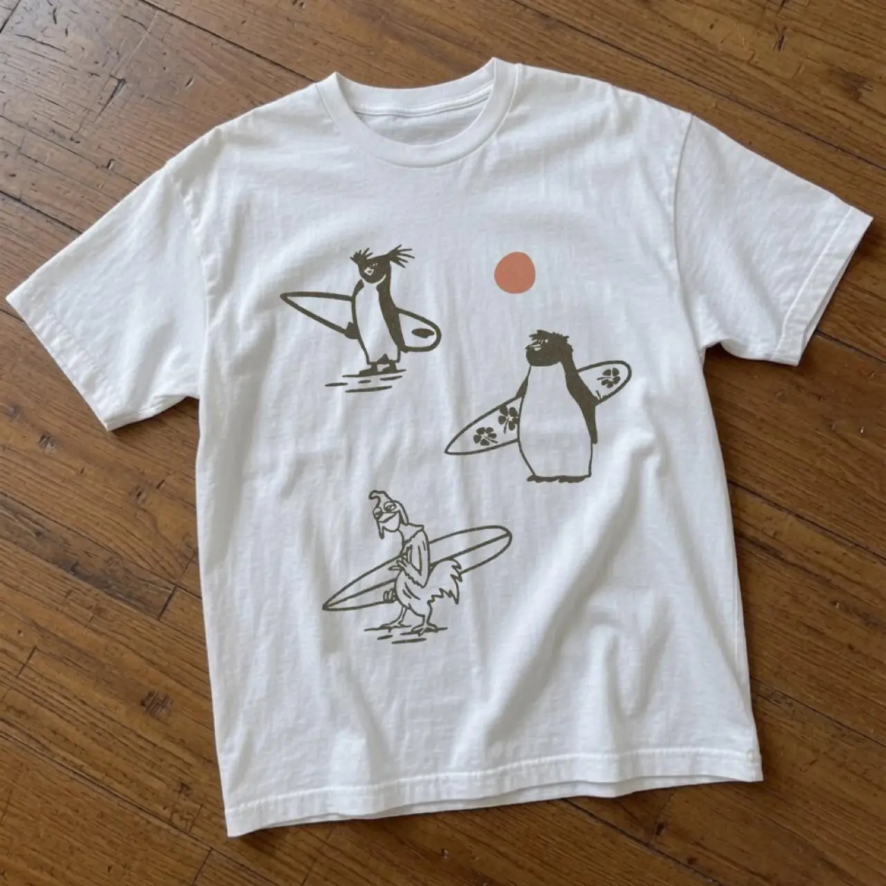Gildan Men's T-shirt, three cartoon penguins surfing with an orange sun, Cute Surfing Penguin Shirt, Beach Graphic Tee, Coastal Aesthetic T Shirt, Minimal Penguin Surf Tee, Summer Vacation Shirt, Funny Animal Graphic Tee, Unisex Oversized Beach Shirt
