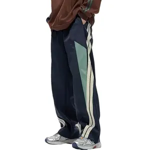 Stylish and comfortable men’s loose-fitting attire suitable for daily use and outdoor activities, featuring sweatpants with side stripes. Elastic Waist Wide Leg Sweatpants