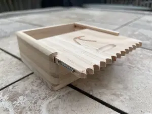 wooden surf wax box with scraper, comb, and fin key