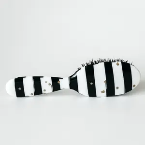 Hairbrush black and white gold dots, boar bristle. Removable brush pad. Slides through tangles great hair care brush!