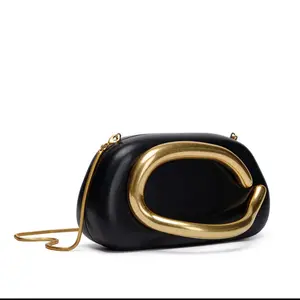 Sculptural Gold Handle Clutch. Price:
