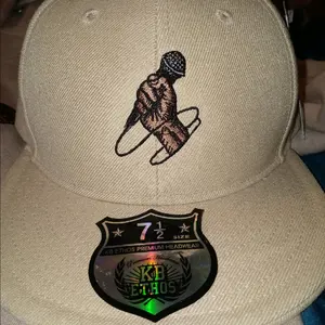 fitted Tan hat with embroidery