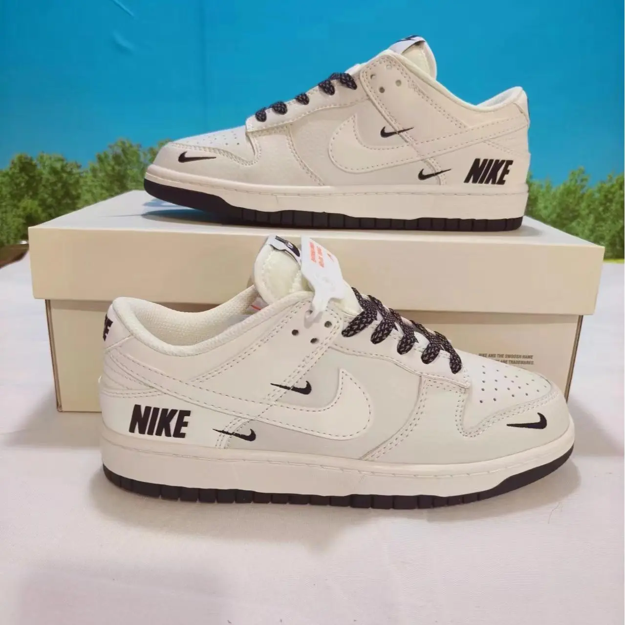 Retro low-top full-grain leather casual sneakers with cushioned foam insoles offering all-day lightweight walking comfort, premium creamy off-white smooth leather decorated with multi mini dark logo printed details and black embroidered laces