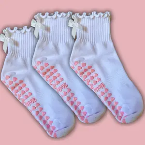 3 pack of white ruffle non slip grip socks with white bow and pink heart grips for pilates, yoga, lagree or barre
