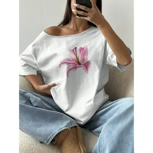 Women's oversized off shoulder T-shirt with asymmetrical collar and lily print, casual loose top, summer casual streetwear, women's clothingRAIMENTRY