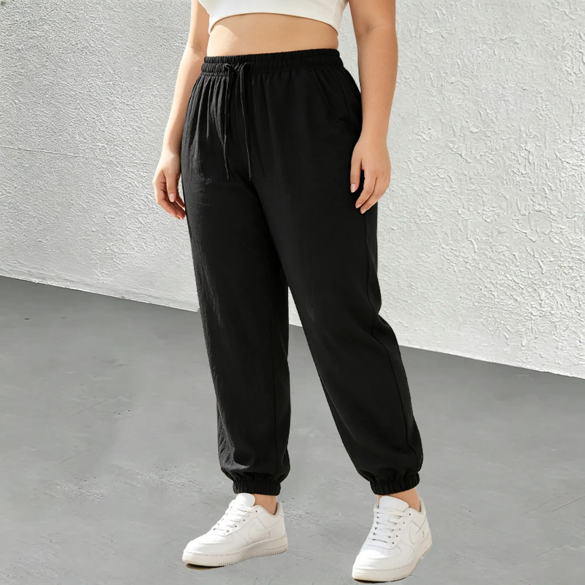 Women’s high-waisted jogger pants with drawstring for a fuller fit, made from breathable linen-like fabric with a crinkled texture—wrinkle-resistant and no ironing needed, featuring a soft drape that resists deformation and suits various occasions.