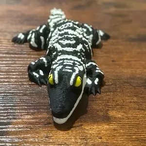 Articulated Baby Alligator Toy with Black and White Stripes and Bright Yellow Eyes for Kids Fun Playful and Colorful Design